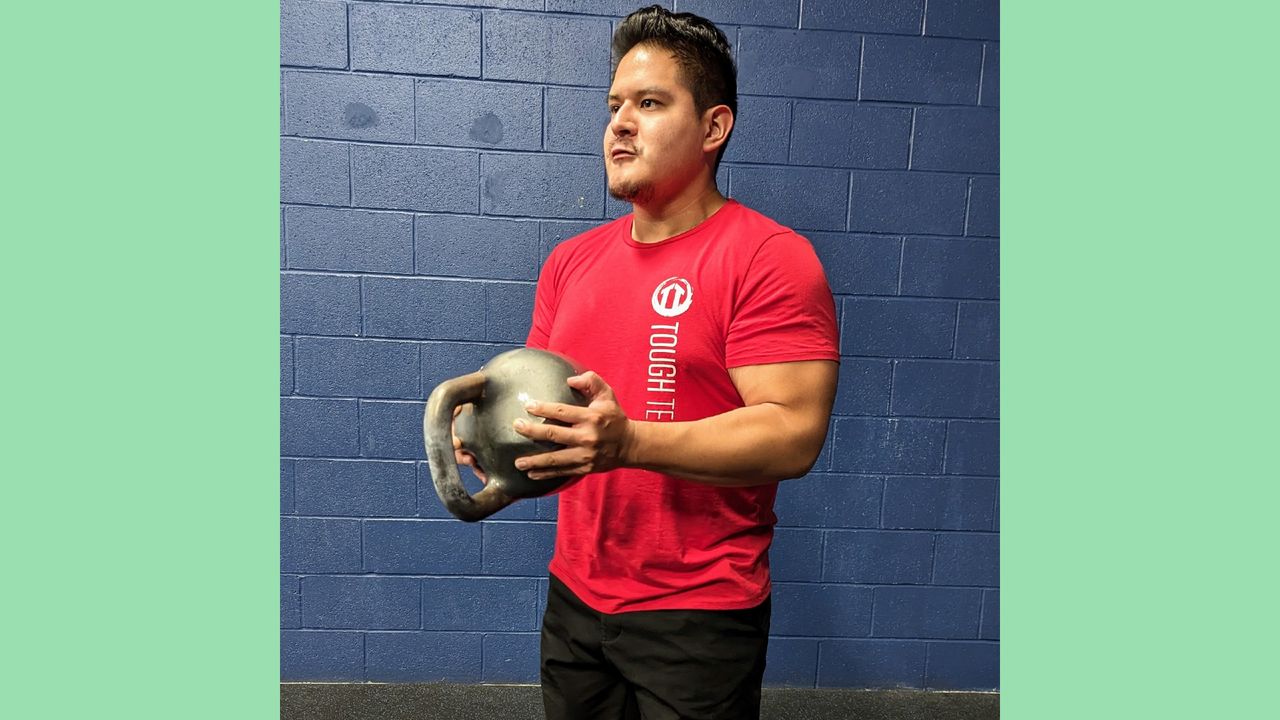 Gio Amatore performing the crush grip kettlebell curl