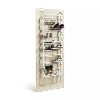 shoe rack with shoes on, hanging on the back of a door