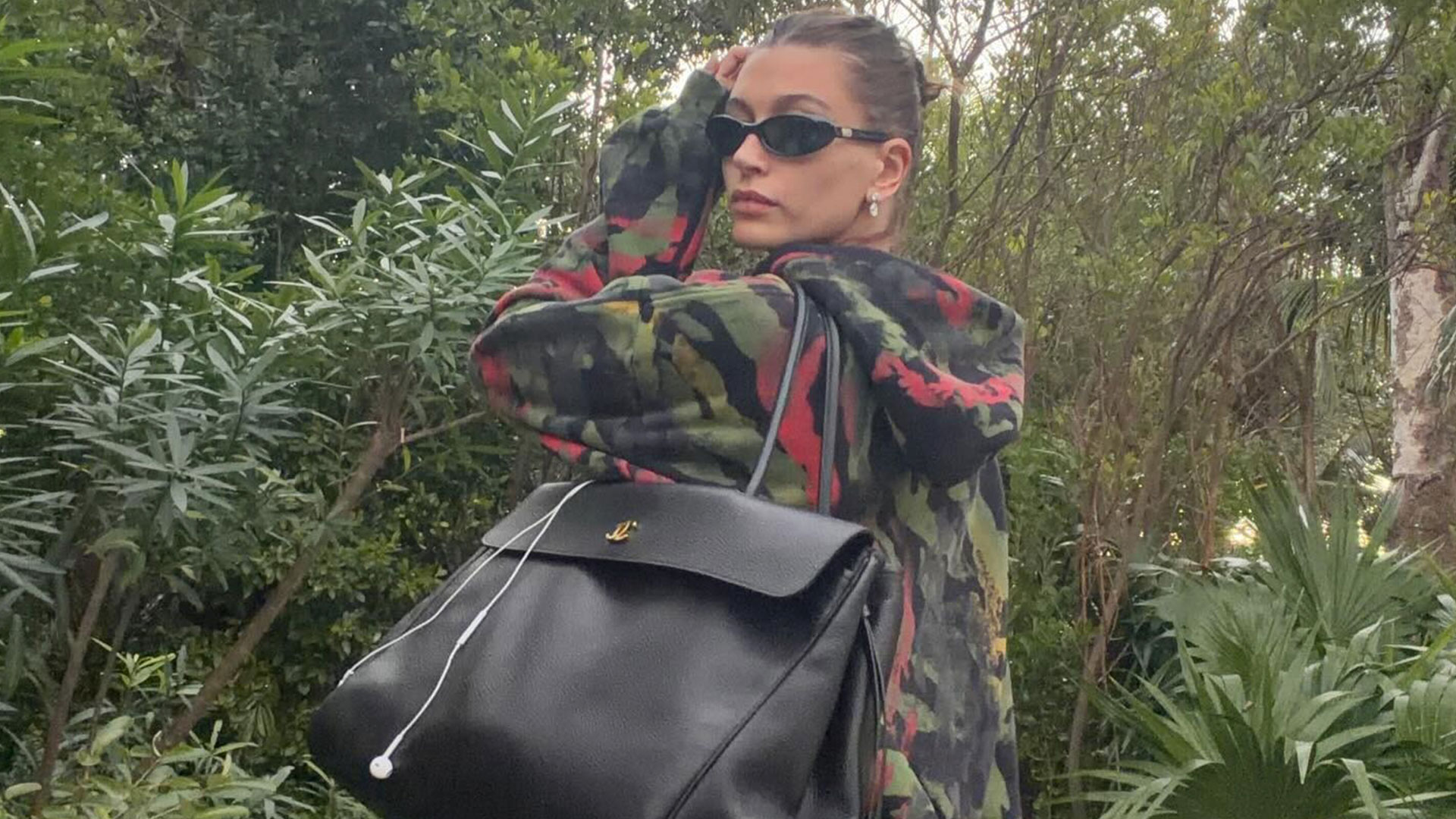 @haileybieber wearing oversized black chanel bag