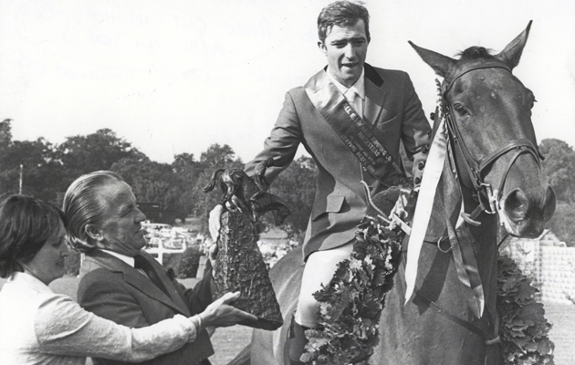 Hickstead Derby winner Michael Whitaker and Owen Gregory receives the Boomerang trophy from Mr and Mrs Christopher Cory in 1980.