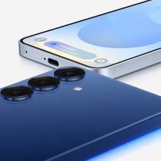 2 Samsung Galaxy S25 phones. 1 laying face down, 1 laying on its back