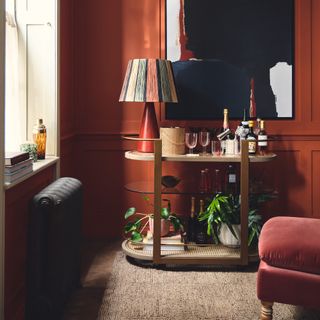 OKA bar cart in rust coloured living room