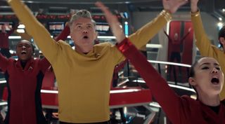 characters in starfleet uniforms dance on the bridge of the enterprise