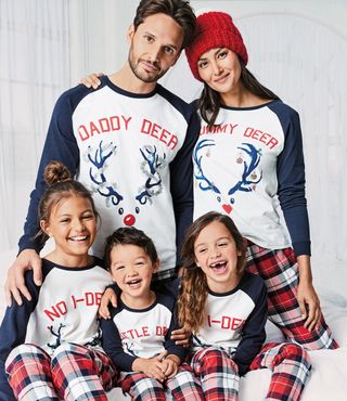 family with matching t-shirt and matching christmas pyjamas