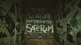 Shot of "Don't Scream, Not Even in the Safe Room" painted sign on wall in A Quiet Place: The Road Ahead