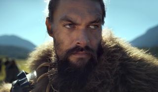 See Jason Momoa stands in the sunny, open fields