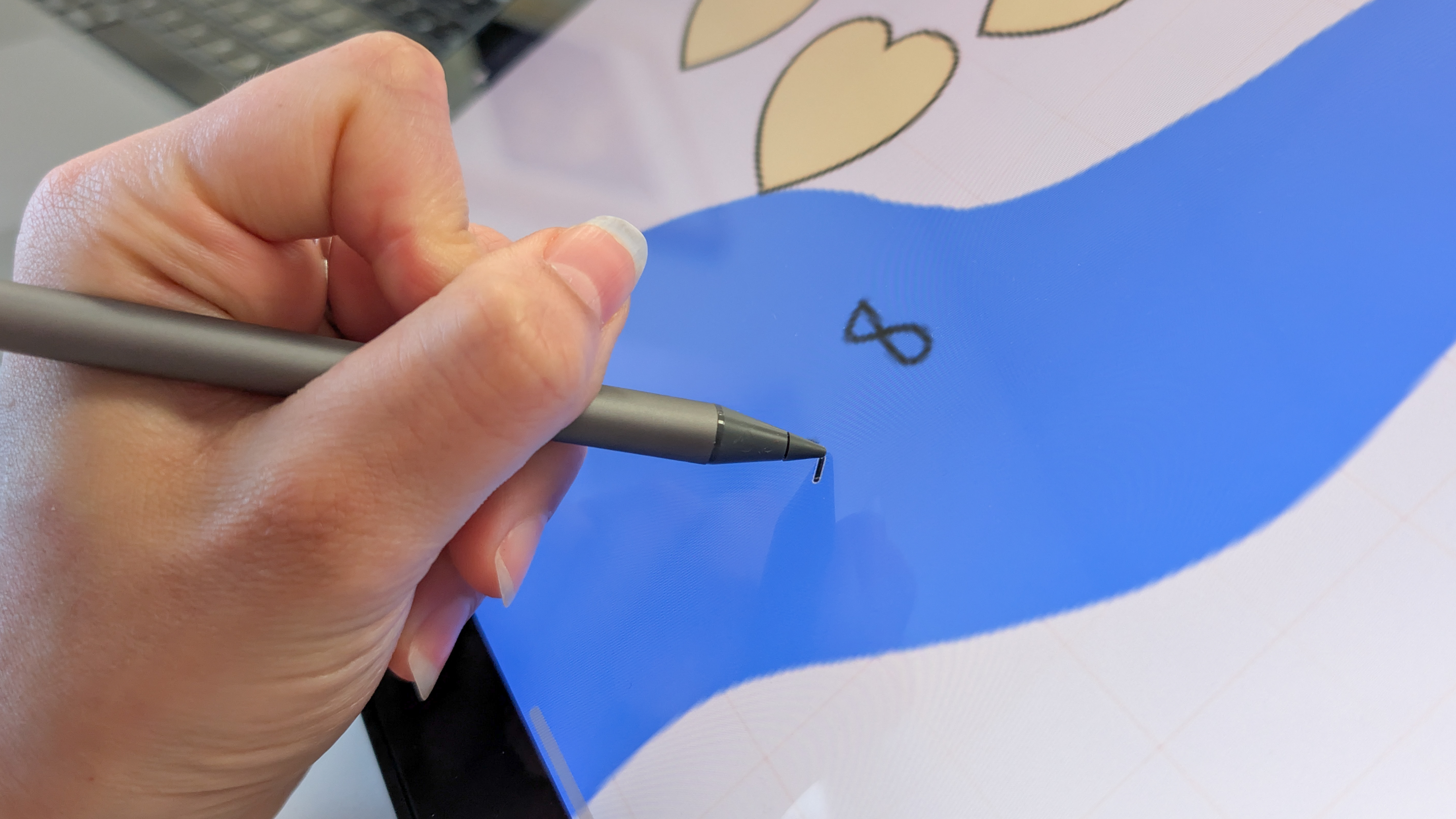 A stylus being used with an Alogic Clarity 6K Touch monitor