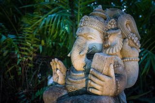 tropical garden ideas with stone sculptures