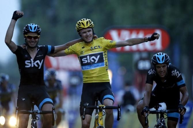 Chris Froome (Sky) celebrates on the Champs Elysees with his teammates