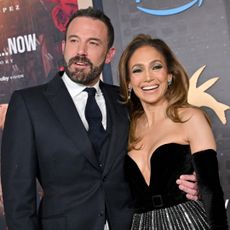 Ben Affleck in a black suit and Jennifer Lopez in a gown with a silver sequined sheer skirt and black strapless bodice with long black gloves at the premiere of This Is Me Now... A Love Story in February 2024