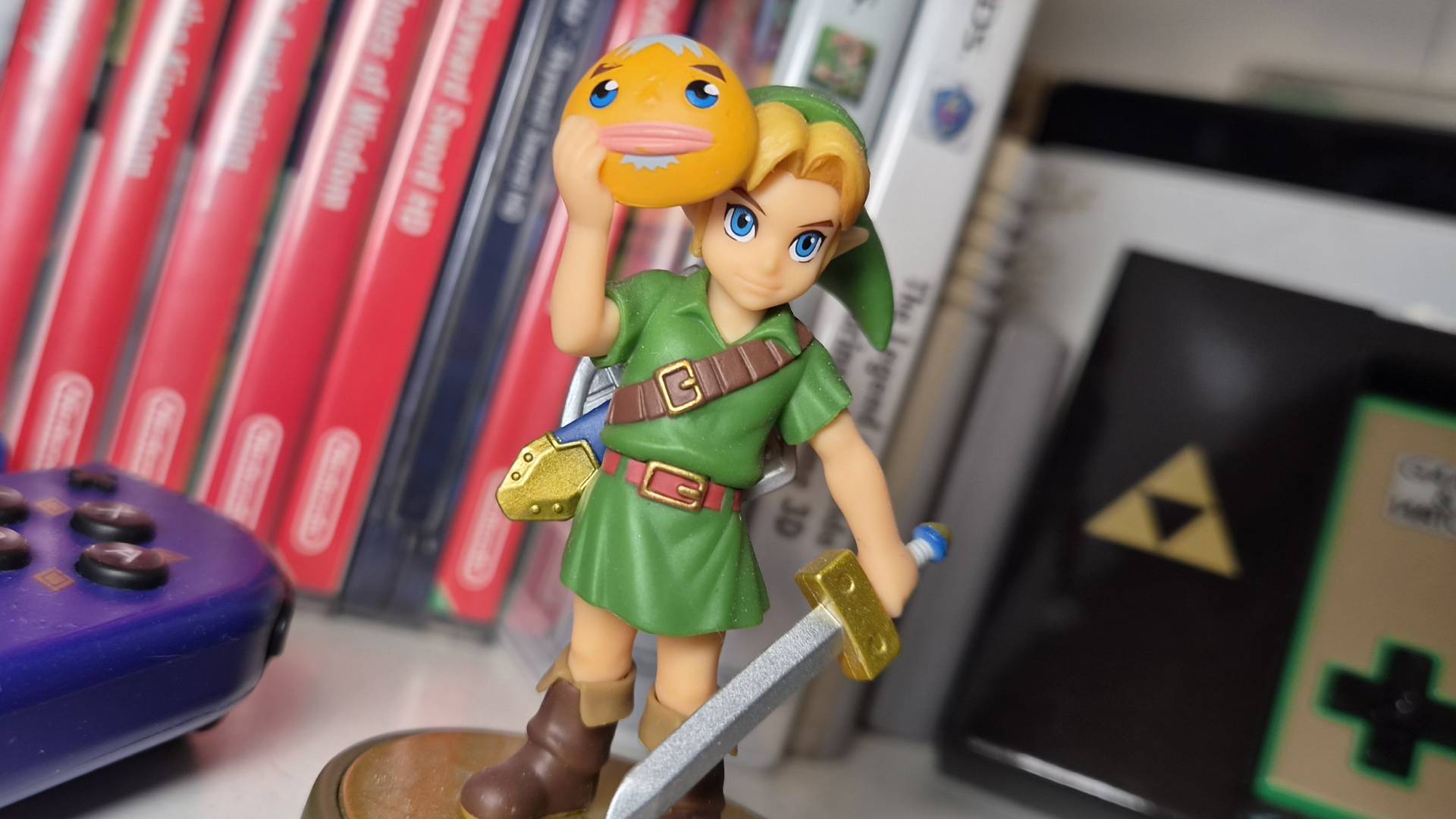 Photo of the Legend of Zelda Majora's Mask Link amiibo with games behind it.
