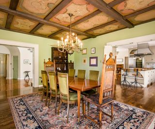 Green dining room, green velvet chairs, wooden floor