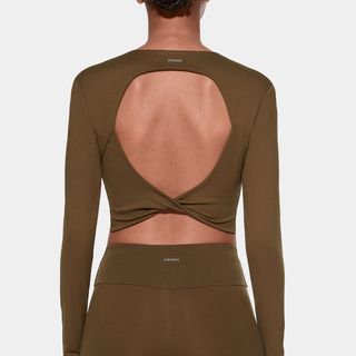 woman wearing open back brown top