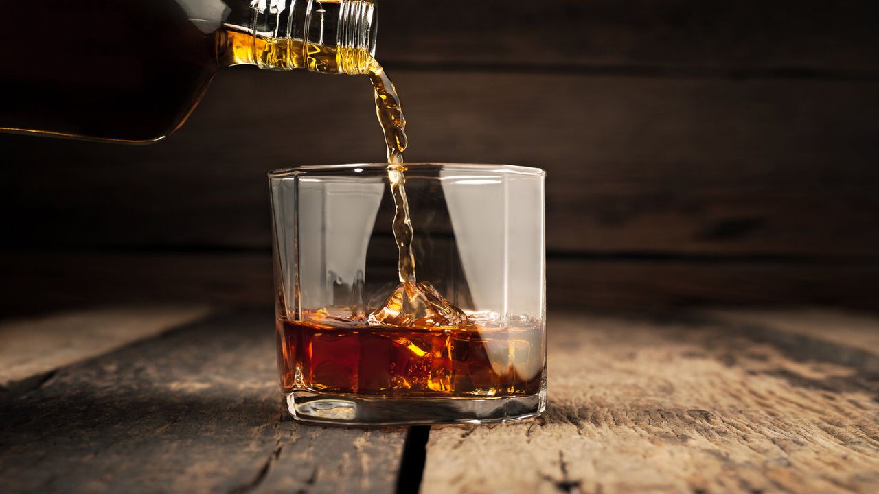 rum being poured into a glass 