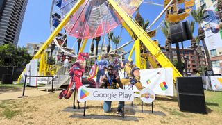 A photo in front of a Ferris wheel with cardboard cutouts of Marvel characters