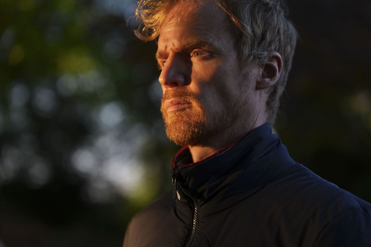 A man at golden hour, illuminated by the sun, natural background
