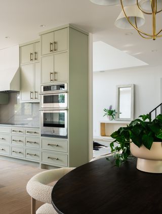 sage green kitchen with black dining table