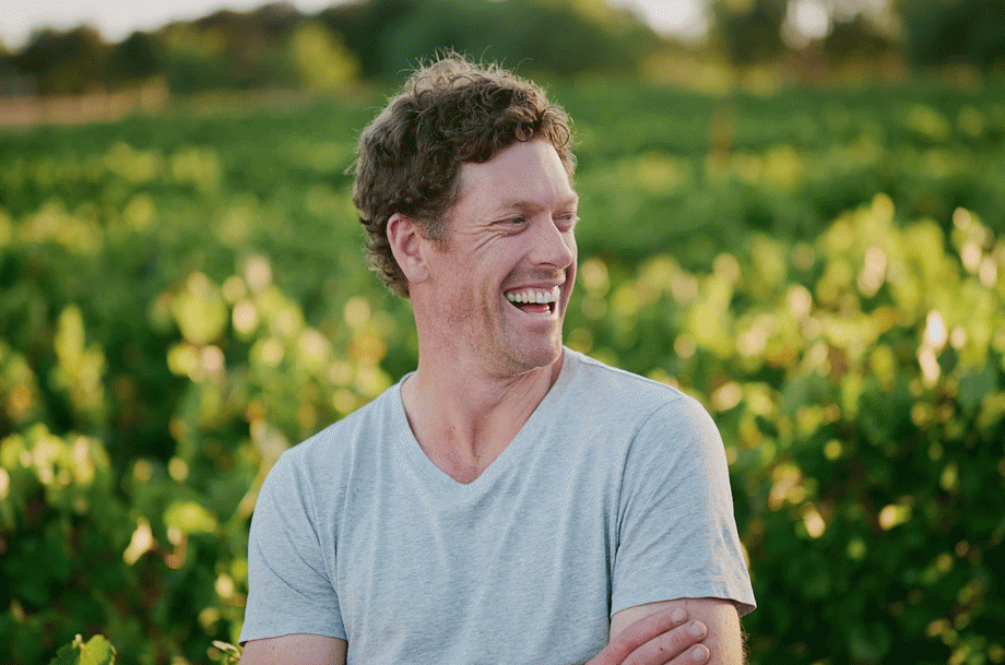 Photo of Nick Farr of By Farr in the vineyard smiling