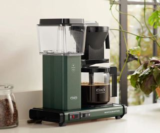 The Moccamaster drip coffee maker in green on the countertop