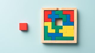 A photograph of puzzle blocks with one piece missing