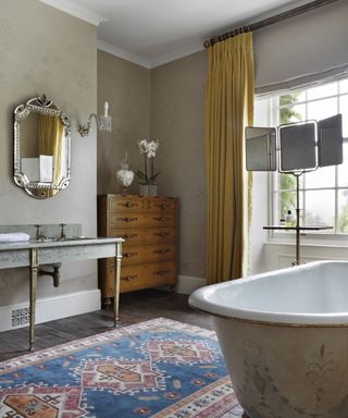 Smart bathroom design with long yellow curtains and patterned rug