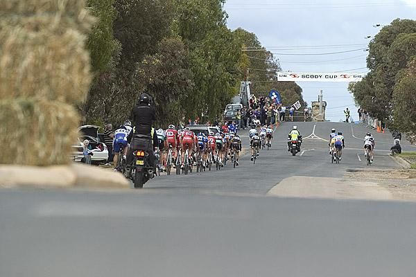 The peloton head up the home straight with riders on the attack.