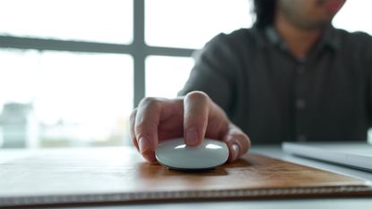 Office worker using a desktop computer and clicking on a mouse button.