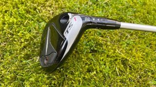 Titleist TSR1 Hybrid resting on the fairway showing its black white and red sole