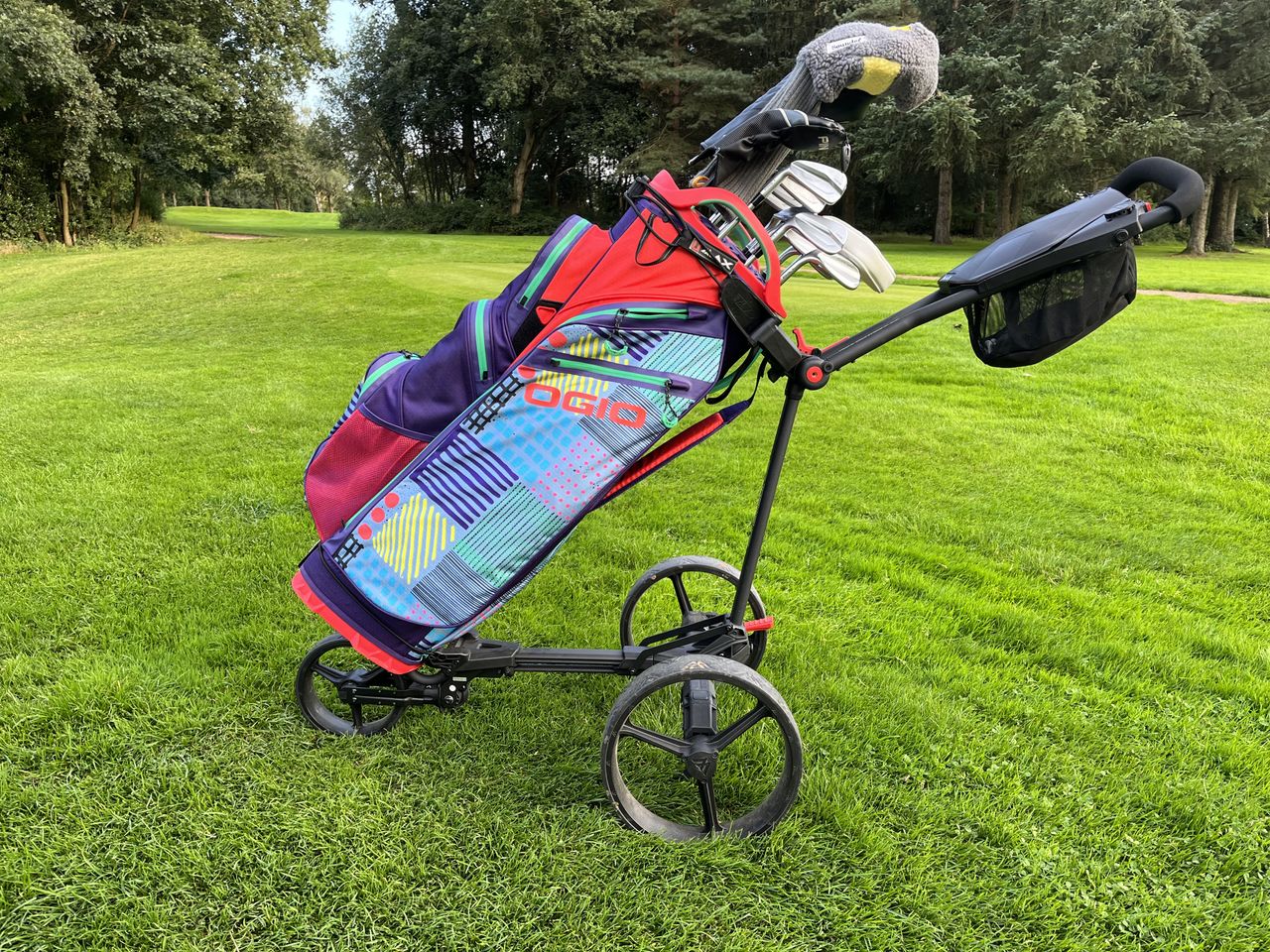 The Ogio All Elements Silencer cart bag on a push cart