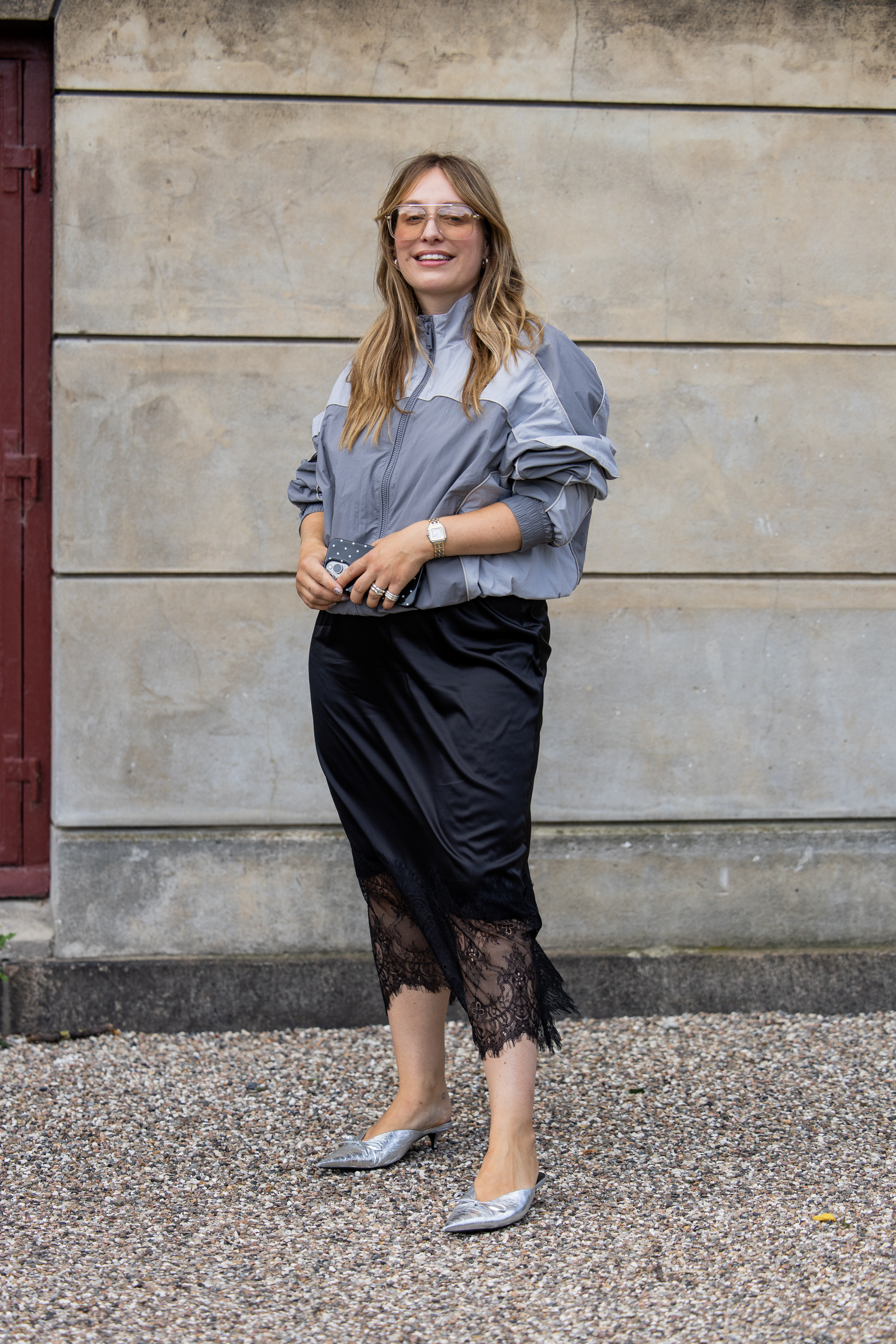 Yara Michels wears grey zipper jacket, black laced skirt outside Munthe during Copenhagen Fashion Week day three on August 06, 2025 in Copenhagen, Denmark.