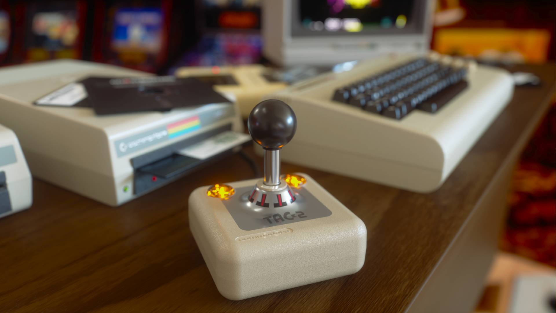 TAC-2 joystick by Commodore in beige next to C64 and Floppy Drive on wood desk.