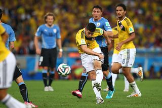 James Rodriguez of Colombia shoots and scoores his team's first goal during the 2014 FIFA World Cup Brazil round of 16 match between Colombia and Uruguay at Maracana on June 28, 2014 in Rio de Janeiro, Brazil.