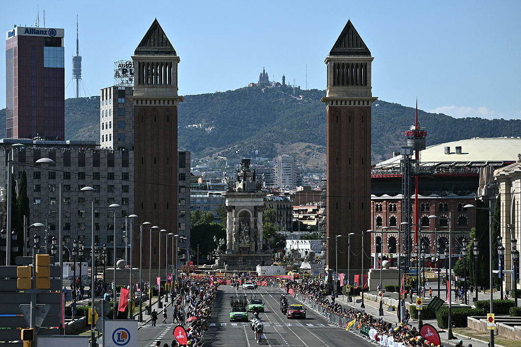 The team Caja Rural-Seguros RGA cycles next to the Venetian Towers at the Pla&amp;ccedil;a d'Espanya during the 1st stage of the 113th edition of the Tour de France cycling race, a 19,6 km team time trial stage in and around Barcelona in northeastern Spain, on July 4, 2026. (Photo by Jeff PACHOUD / AFP)
