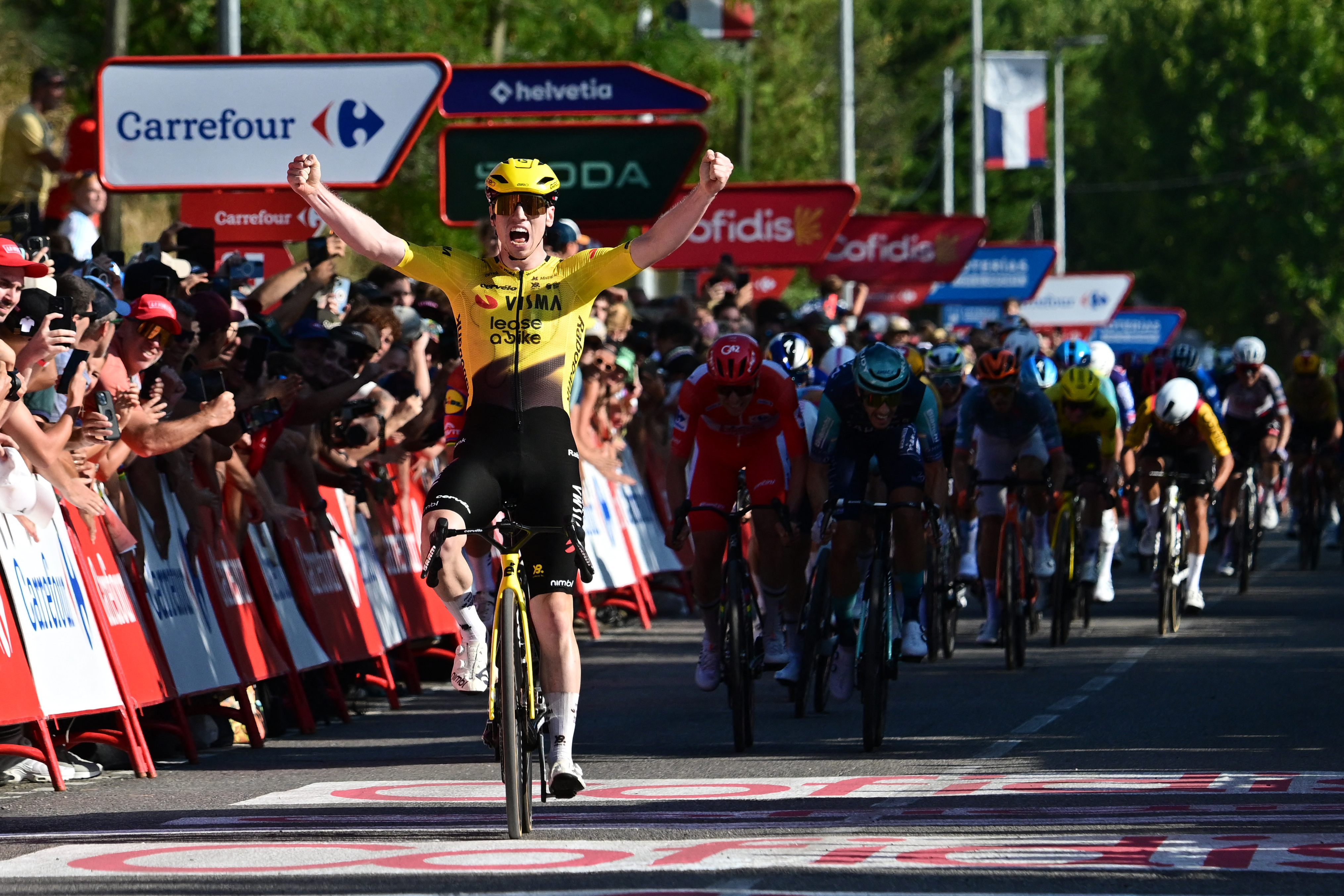 Team Visma-Lease a bike's British rider Matthew Brennan celebrates winning the second stage of the Vuelta a Espana 2026, a 214.3 km race between Monaco and Manosque on August 23, 2026. (Photo by Miguel MEDINA / AFP via Getty Images)