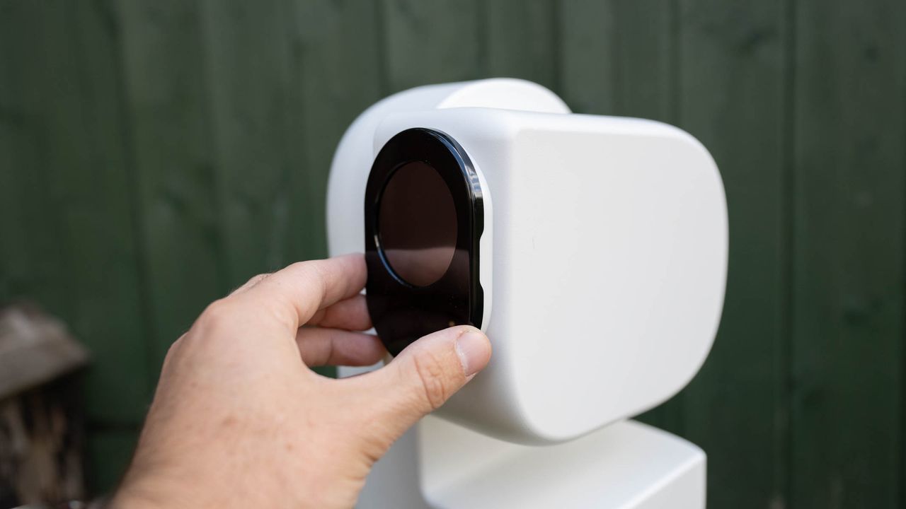 ZWO Seestar S50 Pro on a tripod against a green shed