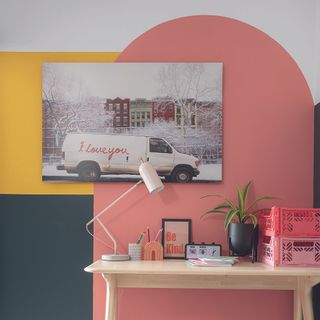 Home office with abstract paint in arches on wall.