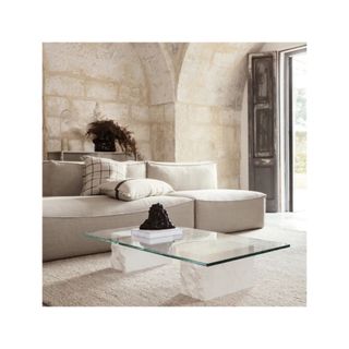 Coffee table with glass rectangular top and 2 stone blocks as legs