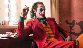 The Joker smoking a cig and looking pensive.