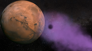 Mars is seen in front of a purplish hazy background of space.