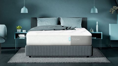 Casper Snow mattress review: Image shows the Casper Snow mattress placed on a light grey bed frame in a blue and green bedroom