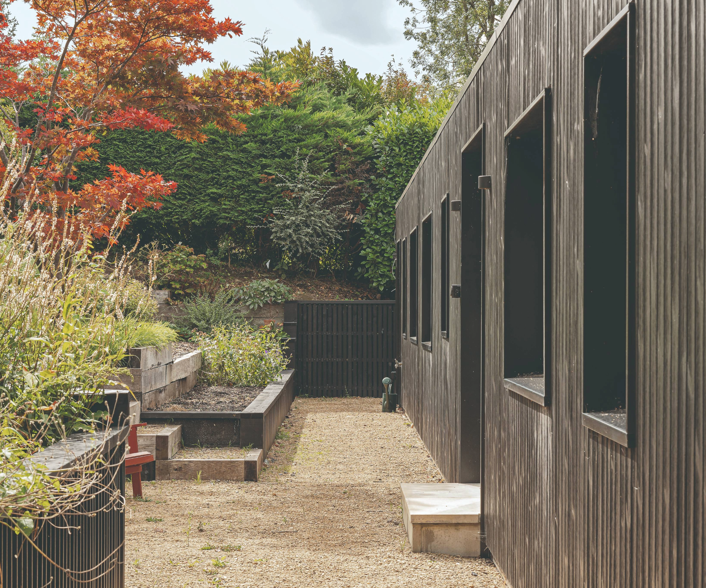 Side of the house with flower beds