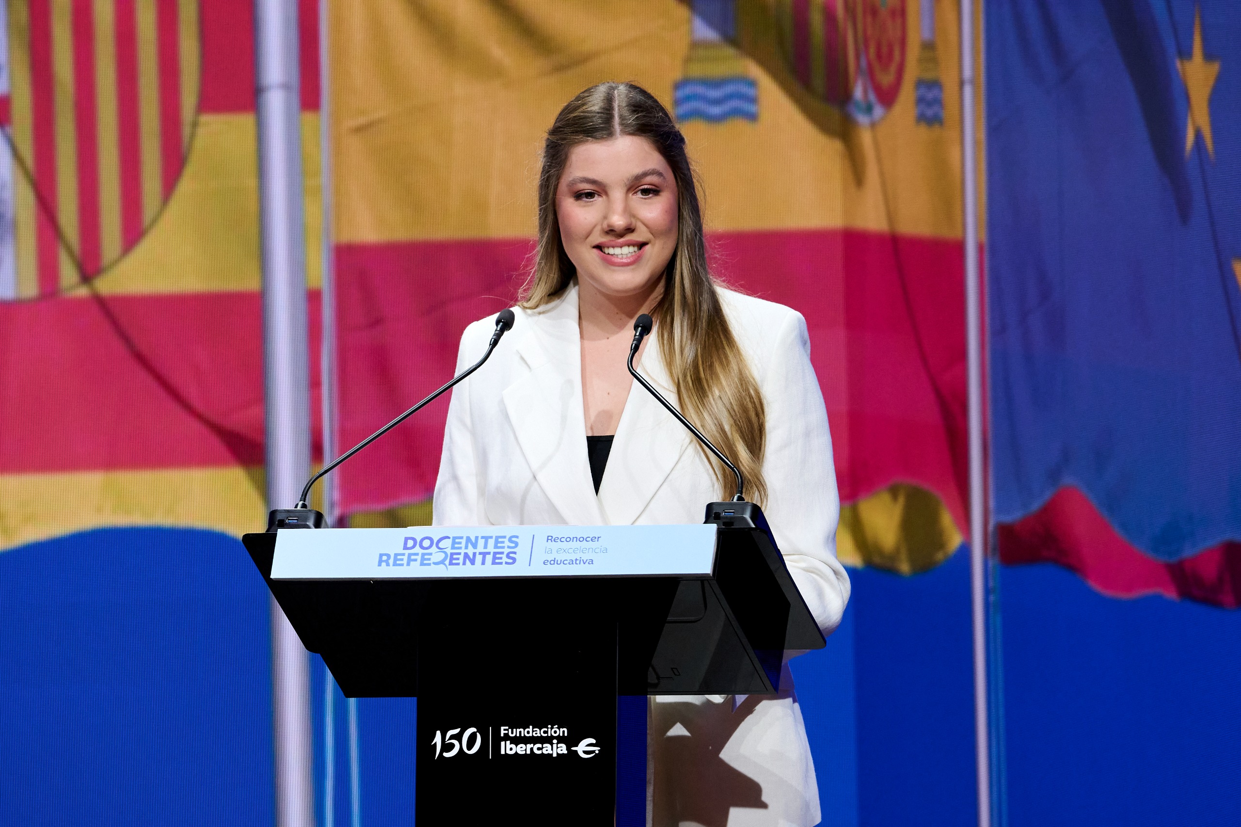 Infanta Sofia wearing a white suit, giving a speech on stage in July 2026