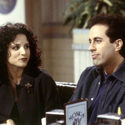 julia louis dreyfus and jerry seinfeld as elaine and jerry sitting at a diner in a still from seinfeld