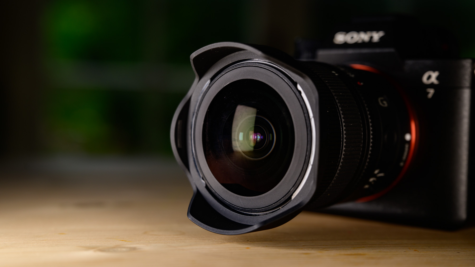 Sony FE 8-14mm F3.5 G fisheye lens attached to a Sony A7R V camera, close up of the bulbous front element