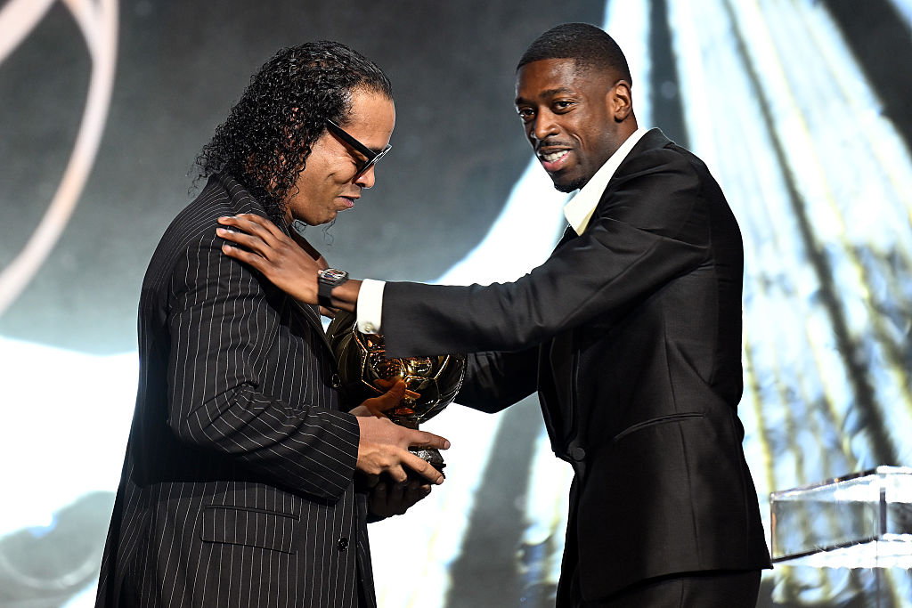 PARIS, FRANCE - SEPTEMBER 22: Ousmane Dembele of Paris Saint-Germain reacts as he receives the men's Ballon d'Or from Ronaldinho during the 69th Ballon D'Or Ceremony at Theatre Du Chatelet on September 22, 2025 in Paris, France. (Photo by Kristian Skeie - UEFA/UEFA via Getty Images)
