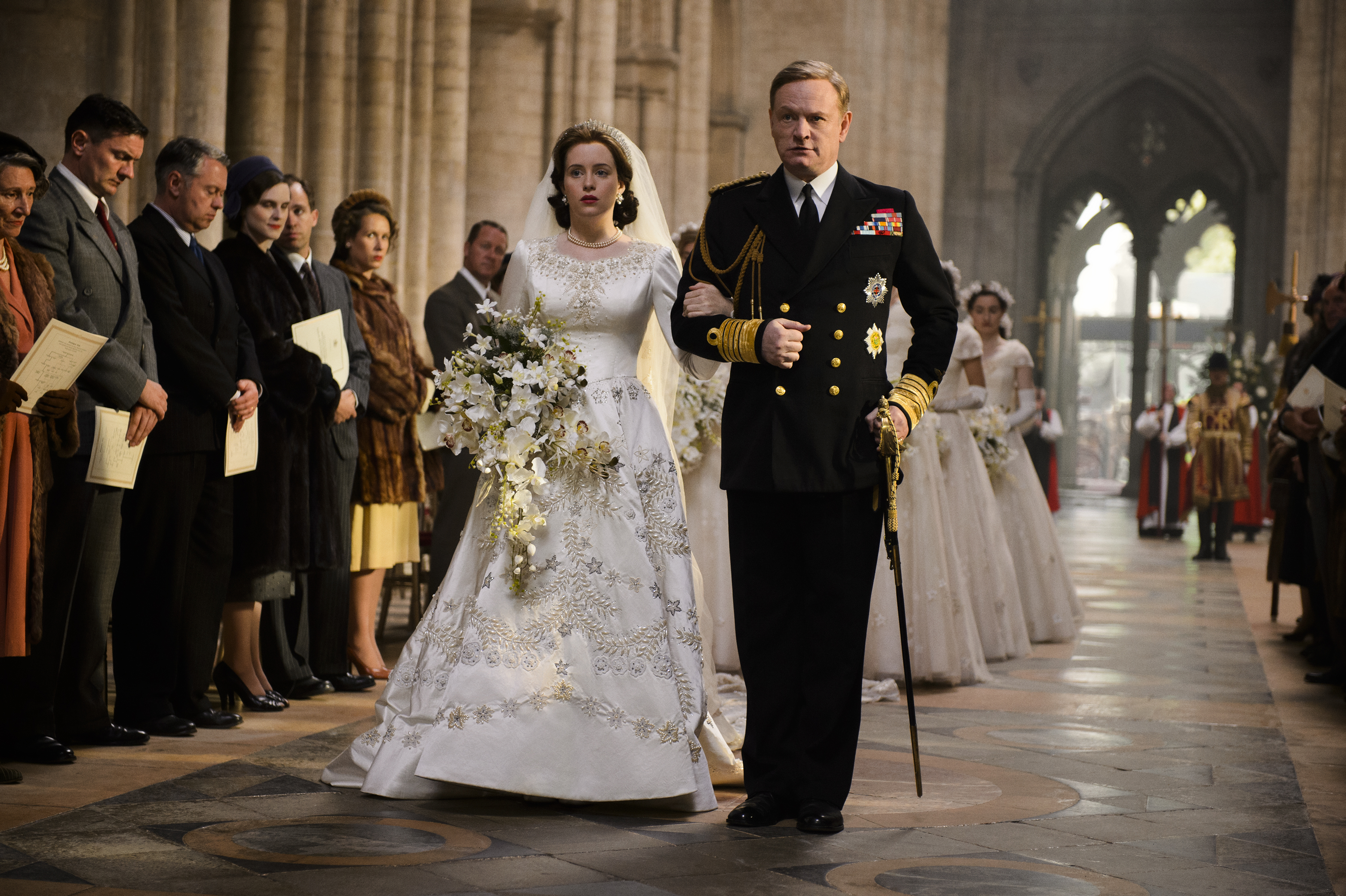 Claire Foy as Queen Elizabeth walking down the aisle at her wedding on The Crown