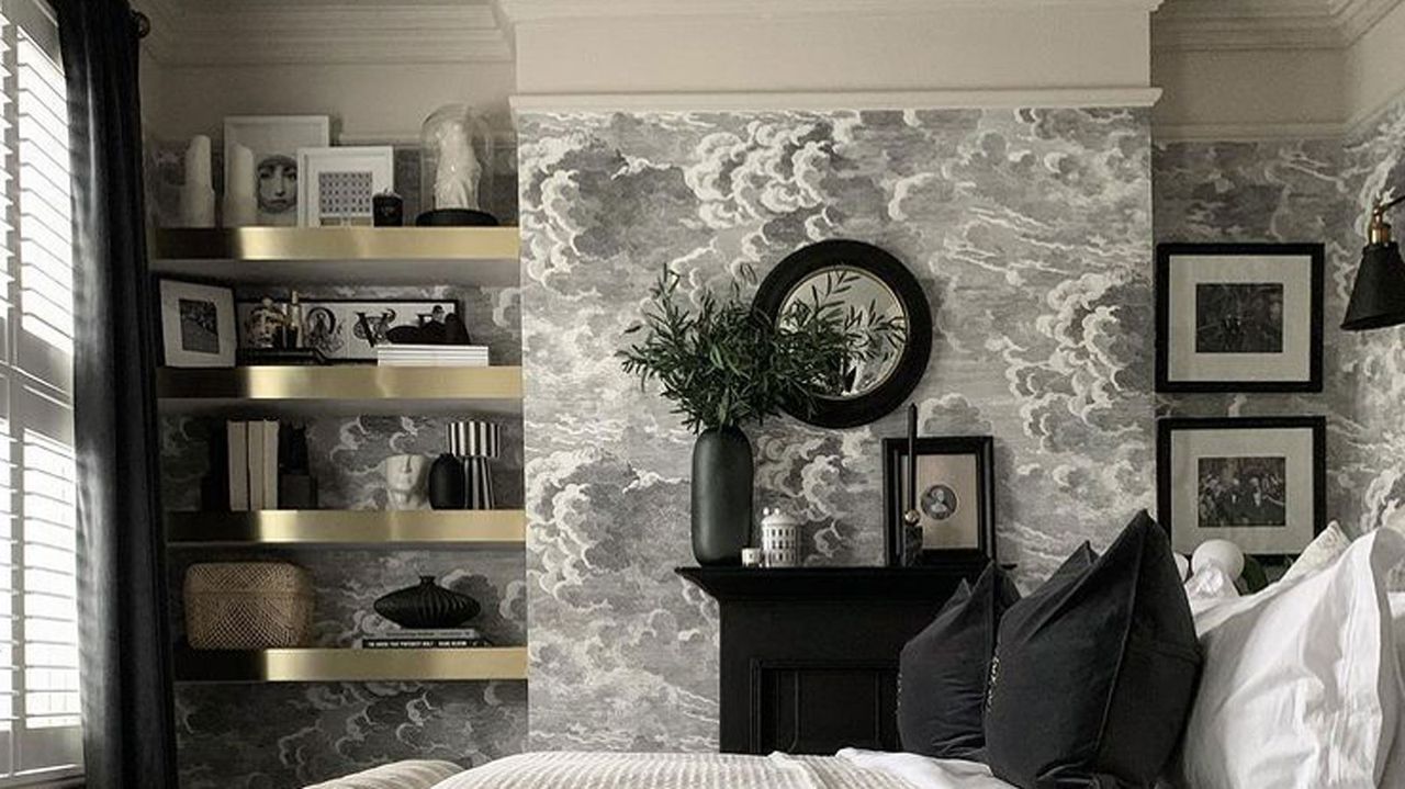 gold shelving in bedroom with grey wallpaper