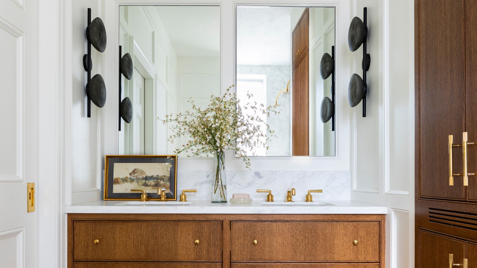 bathroom with white walls, wooden vanity with double sink and mirrors