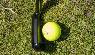 The MacGregor V Foil Speed Driving Iron at address with a yellow ball