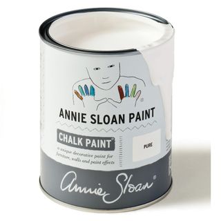A tin of white Annie Sloan chalk paint with a white background